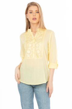 Featured on a solid lemon yellow background, this half button-down tunic is made from 100% natural cotton voile fabric, with tonal floral embroidery on the collar, yoke, and the placket. Model is 5’8” - wearing size small. Model Bust: 34”Hand-wash cold, lay flat to dry.Made in India. Cotton Voile Fabric, Voile Fabric, Embroidery Blouse, Cotton Voile, Lemon Yellow, Yellow Background, Vintage Yellow, Floral Embroidery, Natural Cotton