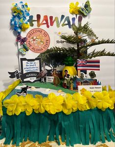 there is a cake with flowers and decorations on the table top that says hawaiii