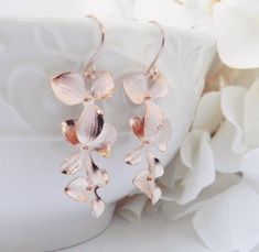 Rose Gold Earrings - Orchid Dangle Earrings - Rose Gold Jewelry - Bridesmaid Earrings - Wedding Jewelry - Gift For Her - Mothers day gift Gorgeous rose gold cascading orchids hang almost two inches from 14 karat rose gold plated French ear wires. These are elegant, light weight and perfect for any occasion! These earrings are perfect for bridesmaids, they make a perfect gift (or to keep for yourself!) Each item is individually gift boxed, ready for giving. Details: Rose gold plated orchid charms Delicate Rose Gold Bridal Earrings Gift, Rose Gold Dangle Flower Earrings For Anniversary, Rose Gold Dangle Bridal Earrings As Gift, Delicate Rose Gold Earrings For Bridesmaid Gift, Earrings Rose Gold, Jewelry Bridesmaid, Rose Gold Jewelry, Rose Earrings, Bridesmaid Earrings