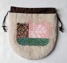 a small purse with an embroidered patch on it