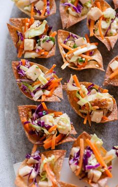 several tortilla shells filled with veggies and chicken