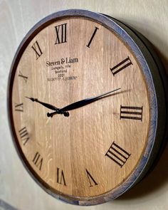 a wooden clock with roman numerals on the face