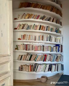 a bookshelf filled with lots of books in a living room next to a door