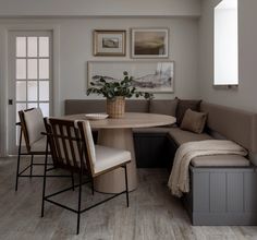 a corner table with four chairs and a bench in front of the door is shown