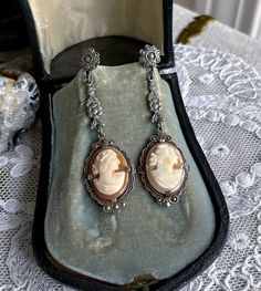 Featuring a gorgeous pair of antique 1910s-20s Edwardian Belle Époque rhodium plated screw back drop  earrings adorned with luminous genuine carved conch shell cameos set in decorative open back pronged settings.  These beauties are in excellent condition with  a lovely patina with all stones intact and accounted for.  Earrings measure approximately 2  inches long at 7.7  grams respectively.  Beautifully designed and handcrafted, elegant and sophisticated! Please feel free to contact me with any Victorian Screw Back Wedding Earrings, Victorian Screw Back Earrings For Wedding, Victorian Cameo Earrings For Formal Occasions, Vintage White Gold Dangle Jewelry, Antique Screw Back Jewelry For Formal Occasions, Victorian Wedding Earrings With Screw Back, Antique Screw Back Earrings For Formal Occasions, Antique Silver Vintage Dangle Jewelry, Victorian Screw Back Wedding Jewelry