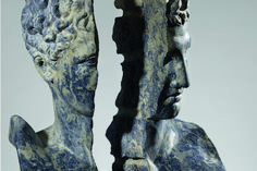 two sculptures made out of blue and white marbles, one is facing each other