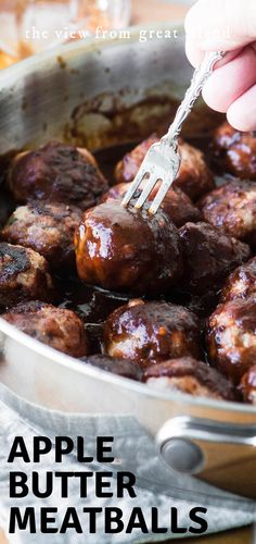 a person is holding a fork over some meatballs in a pan with the words apple butter meatballs on it