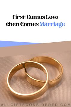 two gold wedding rings with the words first comes love, then comes marriage on it