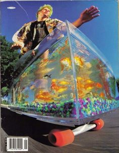 a man riding a skateboard on top of a plastic cone with fish in it