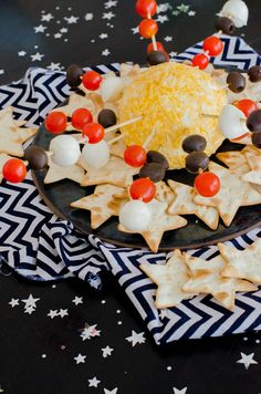 a plate filled with crackers and cheese on top of stars covered in toppings