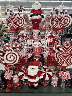 a christmas display in a store filled with candy canes, santa clause and other decorations