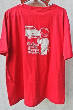 A vintage tee from Crystal Auto Glass which is a company in Eastern Canada.   "God Bless little boys with sling-shots"  A red shirt with white images... See other postings for the same shirt except a red shirt with Black Images, and a grey shirt with Blue Images.  Tag: Bulleton Made in Canada 50% Cotton 50% Polyester XL  - Please always double check measurements to be sure of a good fit In Excellent Vintage Condition... 10/10 -Nicely worn in, one small hole in the center front of the shirt Measu Retro Red T-shirt With Screen Print, Retro Pre-shrunk Red Shirt, 90s Style Red Cotton Shirt, Vintage Red Shirt With Screen Print, Vintage Red Shirt With Graphic Print, Vintage Red Shirt With Letter Print, Retro Red Shirt With Graphic Print, 90s Style Red Cotton T-shirt, Retro Red Graphic Print Shirt