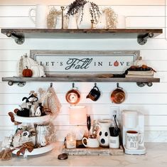 the shelves above the kitchen counter are filled with dishes and coffee cups, mugs and saucers