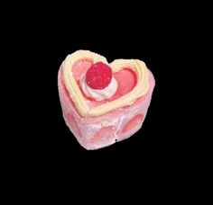 a heart shaped cake with a raspberry on top