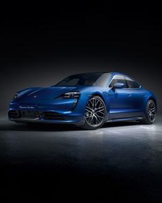 a blue porsche tayr is shown in the dark