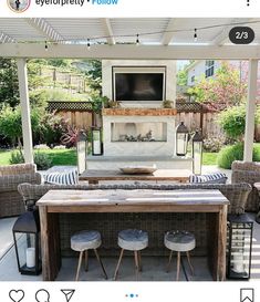 an outdoor living area with furniture and a fire place