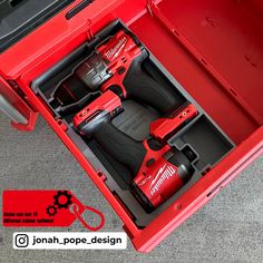 a red tool box filled with tools on top of a white surface and an open drawer