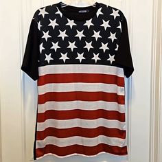 an american flag t - shirt hanging on a door