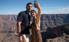 a man and woman taking a selfie at the grand canyon