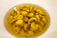 a bowl filled with macaroni and cheese on top of a white countertop