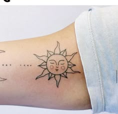 a woman's arm with a sun and moon tattoo on it