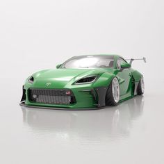 a green sports car is shown on a white surface with no one around it,