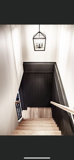 the stairs are black and white with wood treading