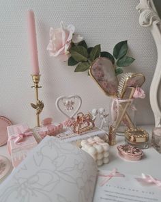 a table topped with lots of pink and white items