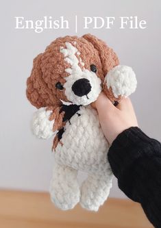 a hand holding a small stuffed dog in it's right hand with the words english / pdf file above it