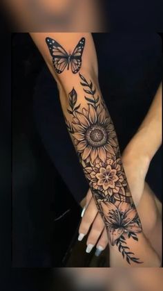 a woman's arm with sunflowers and butterflies on it