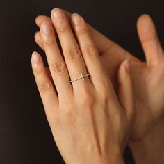 a woman's hand with a diamond ring on it