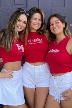 three girls in red shirts and white shorts posing for the camera with their arms around each other