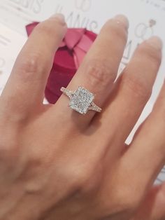 a woman's hand with a diamond ring on it