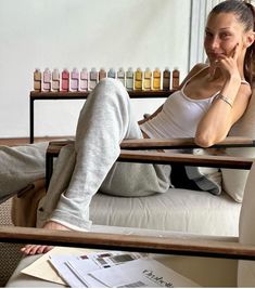 a woman sitting on top of a white chair