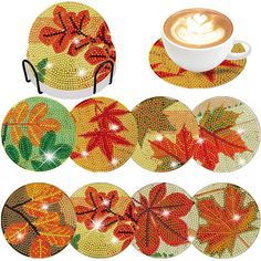 six coasters with autumn leaves on them and a cup of cappuccino