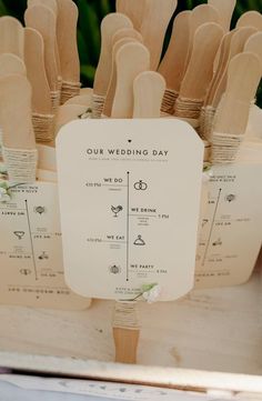 a bunch of wooden utensils sitting on top of a white box with the words our wedding day written on them