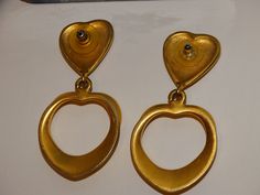 "The earrings are gold-tone metal featuring two hearts, size 2.5\" inches tall x 1 1/4\" inch wide, weight 33.8 grams in excellent condition." Gold Double Heart Metal Earrings, Gold Metal Double Heart Earrings, Vintage Double Heart Pierced Earrings, Vintage Double Heart Earrings For Anniversary, Vintage Gold Double Heart Earrings, Vintage Double Heart Earrings, Gold Double Heart Vintage Earrings, Vintage Gold Earrings For Valentine's Day, Traditional Gold Heart-shaped Earrings