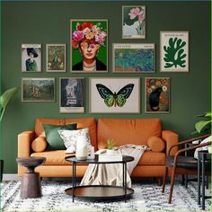 a living room with green walls and pictures on the wall above the orange couches