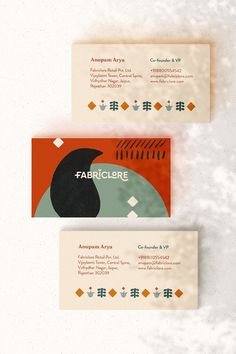 three business cards with different designs on them