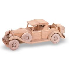 a wooden toy car is shown on a white background