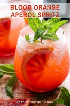 blood orange aperol spritz in a glass with mint garnish