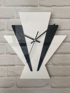 a white and black clock on a brick wall