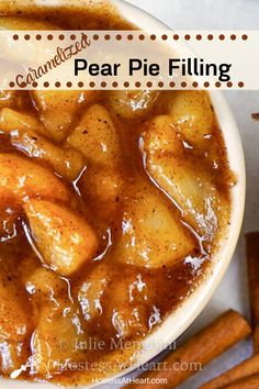 a bowl of pear pie filling with cinnamon sticks