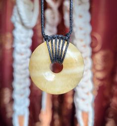 Yellow Calcite is believed to promote new beginnings, personal will, and opportunities. An adjustable necklace with a sliding square knot closure. This necklace can be as long as fifteen inches, or can be tightened into a choker. The accent beads are made of metal alloy, and the dimensions are as follow: Howlite: 6mm tall, 6mm wide Onyx: 6mm tall, 6mm wide Bead 1 - 17mm tall, 9mm wide Bead 2 - 9mm tall, 5mm wide Bead 3 - 8.5mm tall, 5mm wide Bead 4 - 11.5mm tall, 5mm wide Bead 5 - 13mm tall, 5mm Crystal Donut Necklace, Gift Round Pendant Necklace With Sliding Knot, Gift Jewelry With Sliding Knot And Round Pendant, Adjustable Yellow Necklace With Round Pendant, Spiritual Necklace With Sliding Knot As Gift, Spiritual Necklace With Sliding Knot For Gift, Adjustable Yellow Round Pendant Necklace, Donut Necklace, Yellow Calcite