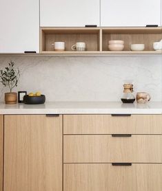 a kitchen with wooden cabinets and white counter tops