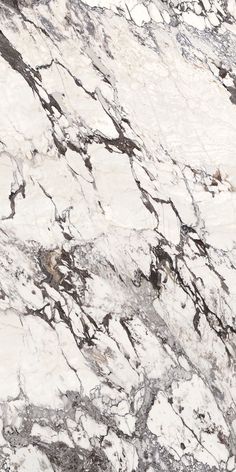 a white and brown marble counter top with black veining on the edges, in an angled view