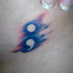 a woman's stomach with blue and red ink on it