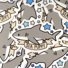 some stickers that are on the side of a wall with sharks and stars around them