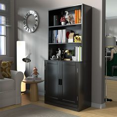 a living room filled with furniture and a clock on top of the bookcases