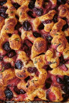 a close up of a pie in a pan with fruit toppings on the crust